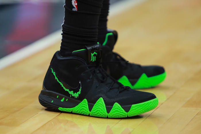 Black and green Nike Kyrie 4 shoes.